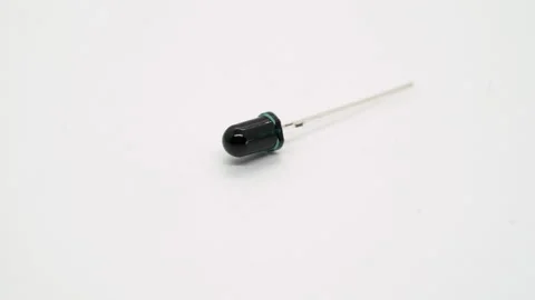 Black LED or flame sensor electronic component rotates on white background. Vidéo 169365483