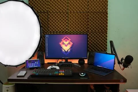 A black led video flash light on a tripod in a studio beside a workstation Stock Photos