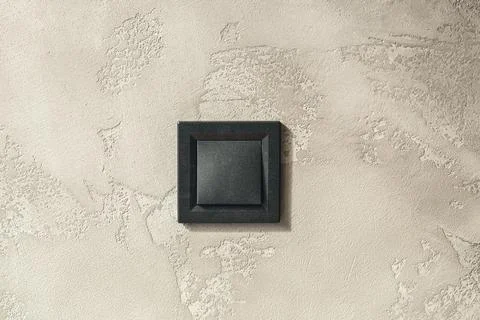 Black light switch on grey background, close up. Stock Photos