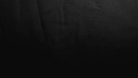 Black linen fabric texture undulating under slow cinematic panning shot with moo Stock Footage 337550226
