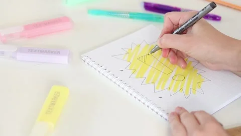 Black liner shading exclamation mark in notebook on white desk Stock Footage 331802190