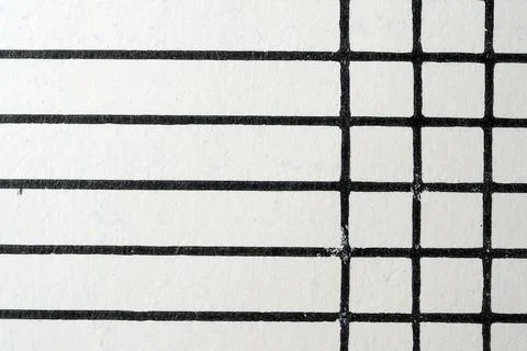 Black lines create a pattern on textured white surface Stockfoto's