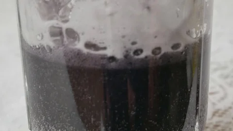 In black liquid is actually added white powder from this stands Stock Footage 116956423