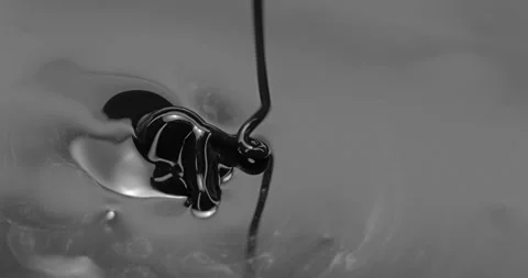 Black liquid stream forms glossy ripples and flowing monochrome shapes Stock Footage 344971569