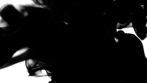 A black liquid on a white background fills the frame on the left side. Stock Footage 242491082