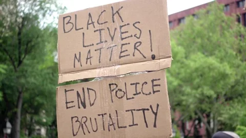 Black Lives Matter and end police brutality sign at peaceful protest NYC Stock Footage