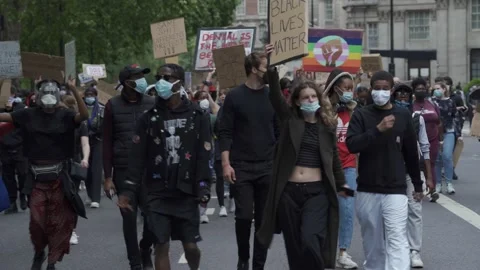 Black Lives Matter protesters marching on Park Lane in London Stock Footage 131845197