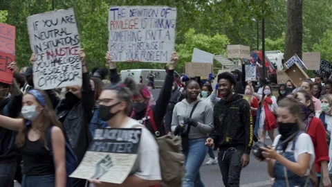 Black Lives Matter protesters marching in London for George Floyd Stock Footage