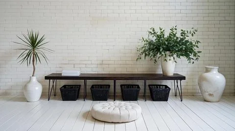 Black long seat in front of white brick wall, 3D illustration, loft style. Stock Photos