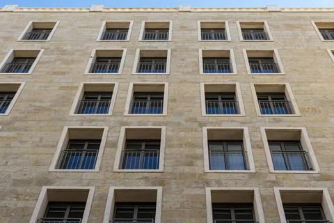 Black long thin rectangular windows in the new building. Many windows dark br Stock Photos