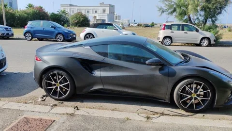 A black Lotus parked on the seafront Stock Footage 327475114