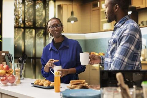 Black lovers chatting in the kitchen over fresh roasted coffee in cups at home Fotos Stock
