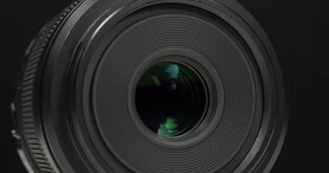 Black macro camera lens, zoom-in video on black backdrop Stock Footage 335108781