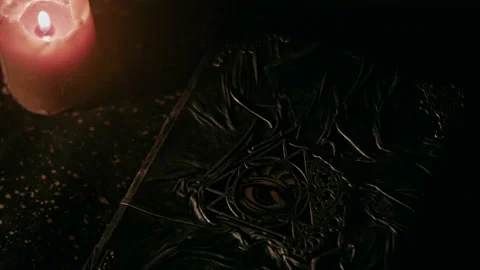 Black Magic Book with Burning Candle Flame Occult Witchcraft Scene Stock Footage 158363635