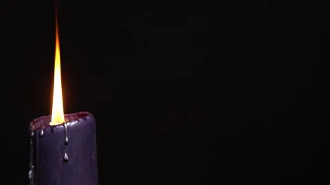 Black magic burning candle with dark background, selective focus. Magical Stock Footage 331224394