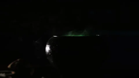 Black magic cauldron with a mysterious potion and green smoke. Stock Footage 285369339