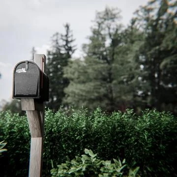 Black mailbox on a wooden post Stock Illustration