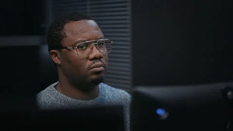 Black Male Computer Engineer Studying Code on Computer Screen Stock Footage 324021485