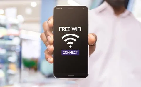 Black male demonstrating smartphone connected to free wifi hotspot Stock Photos