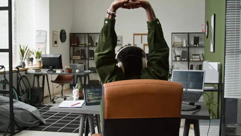 Black Male Developer Stretching while Running Vibe Coding Agent on Computer Stock Footage 335938336