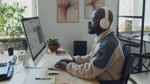 Black Male Developer in Wheelchair Testing AI Image Generation Software Stock Footage 293169104