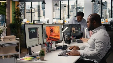 Black male game developer creating futuristic space video game Stock Photos