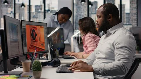 Black male game developer creating futuristic space video game Stock Photos
