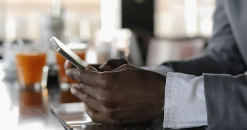 Black male hands using smart phone touchscreen in cafe Stock Footage 85505106