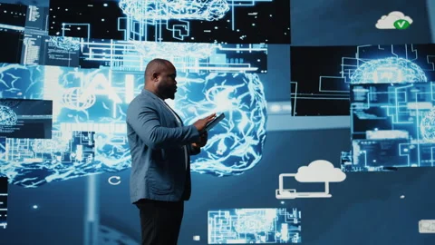 Black male IT engineer examining digital AI brain interface on dashboard Stock Footage 312305837