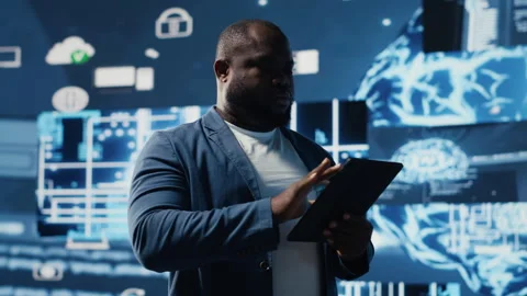 Black male IT engineer examining digital AI brain interface on dashboard Stock Footage 312478505