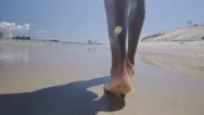 Black Male Legs And Feet Walk On Sandy Beach Under Blue Sky In Australia. Medium Stock Footage