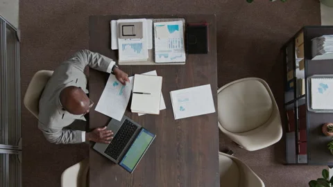 Black Male Manager Working on Presentation Draft on Laptop in Office Stock Footage 311845363