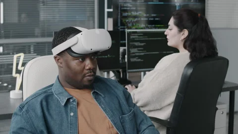 Black Male Program Developer in VR Glasses Using Computer in Office Stock Footage 276205080