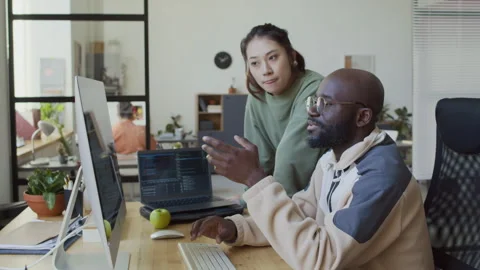 Black Male Programmer Complaining about Bug in Code to Asian Female Colleague Stock Footage 293172222