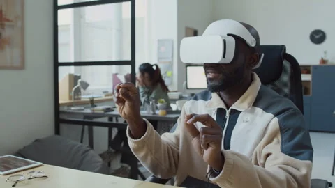 Black Male Programmer in VR Headset Browsing Internet in Augmented Reality Stock Footage 293168808