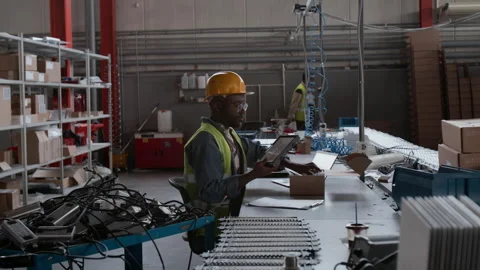 Black Male Quality Controller Inspecting Product Sample at Lighting Factory Stock Footage 300139373