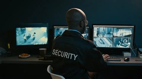 Black Male Security Officer Posing Against Cctv Screens at Night Stock Footage 330607277