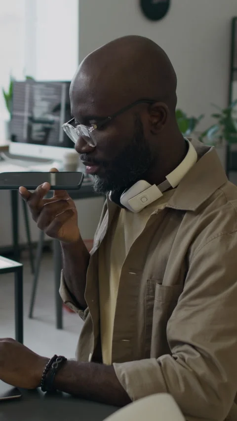Black Male Senior Developer Talking on Phone while Coding at Workplace Stock Footage 299201962