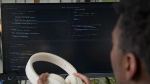 Black Male Software Engineer Watching AI Vibe Coding Agent Writing Script Stock Footage 335939913