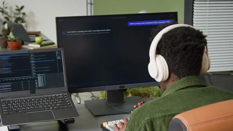 Black Male Software Engineer Watching AI Vibe Coding Agent Writing Script Stock Footage 335941655