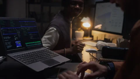 Black Man and Colleague Developing Software and Coding Late in Office Stock Footage 338417669
