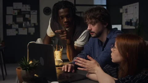 Black Man and Colleagues Analyzing Project on Laptop in Late Night Office Stock Footage 338414086