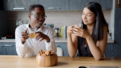 Black man and mixed race woman enjoying a delightful office break with cookies Stock Footage 335751622