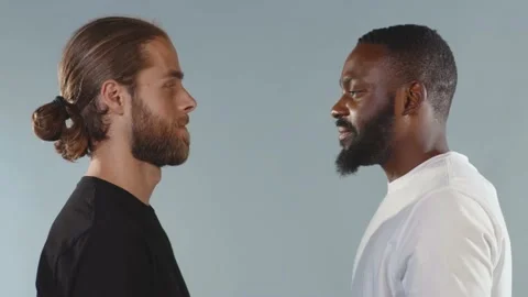 Black man and white man hugging and smiling on grey background interracial Stock Footage 133640485
