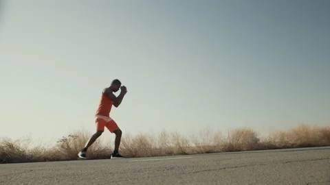 Black man athlete struggles shadow fight background of sky, front view. Male Stock Footage 178865015