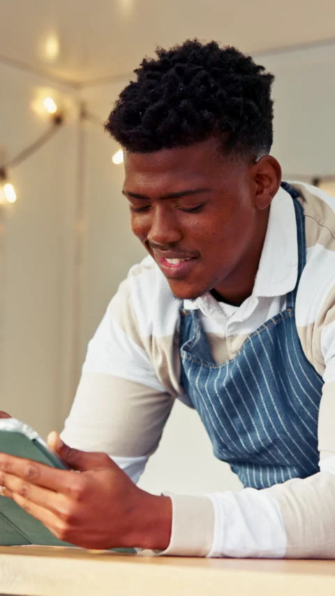 Black man, barista and tablet with scroll for menu, social media and break in 動画素材 338095183
