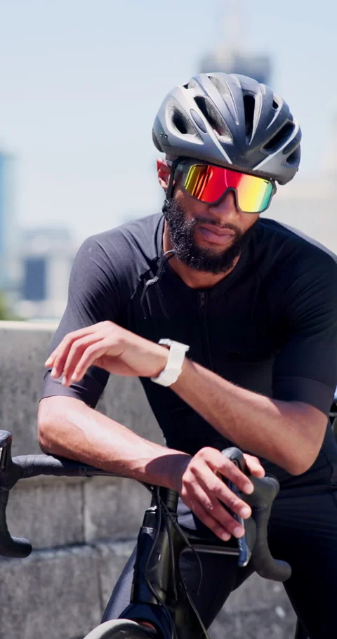 Black man, bicycle and smart watch in city for training with timer, thinking or Stock Footage 327888592