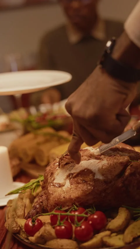 Black Man Carving Roast Turkey for Thanksgiving Celebration Stock Footage 344865621