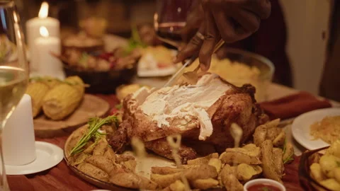 Black Man Carving Roasted Turkey for Thanksgiving Celebration Stock Footage 344859691