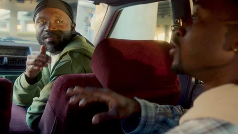 Black Man Chatting with Friend while Sitting in Backseat on Vintage Car Stock Footage 285457669